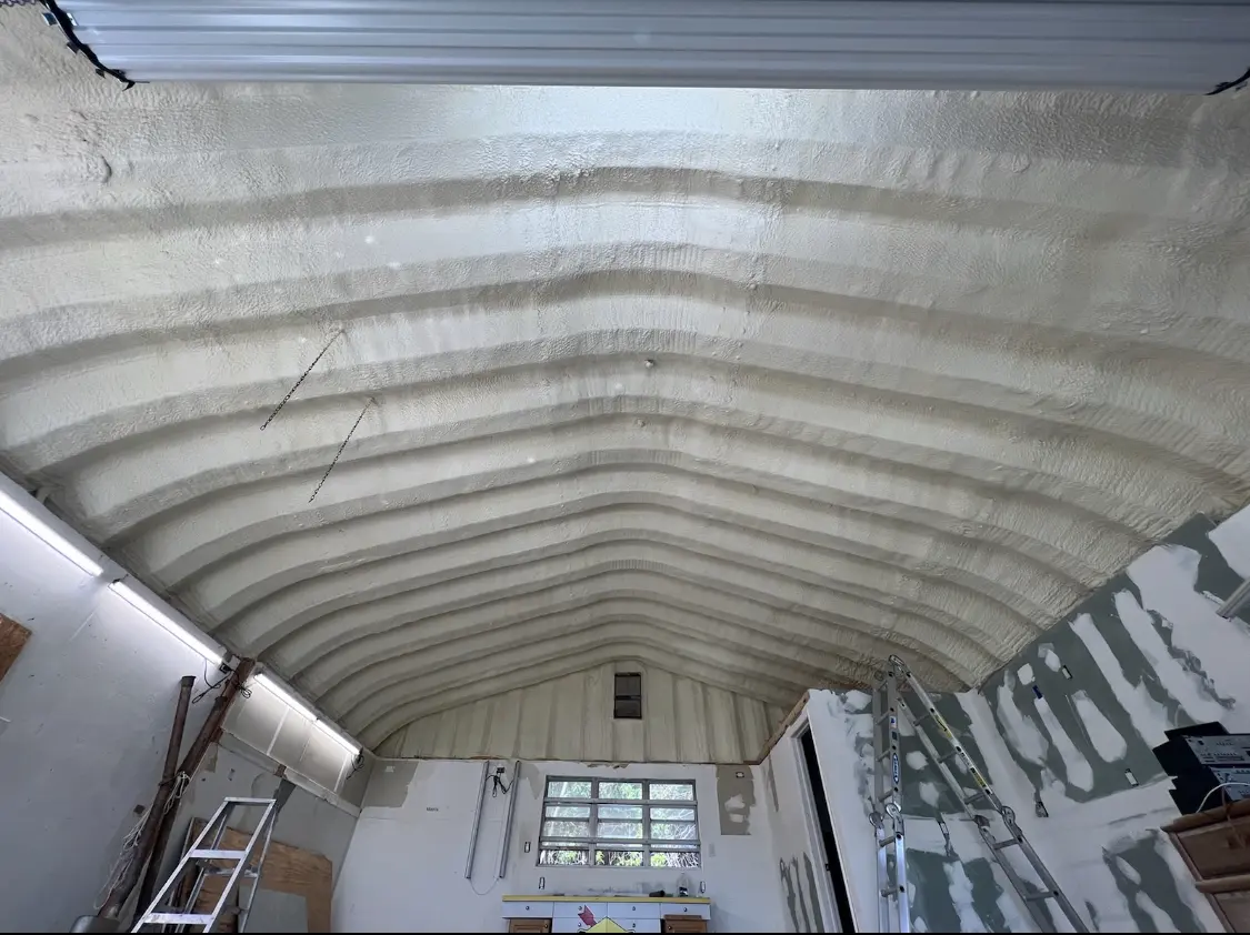 Spray polyurethane foam applied to the underside of a metal roof deck in Goffstown